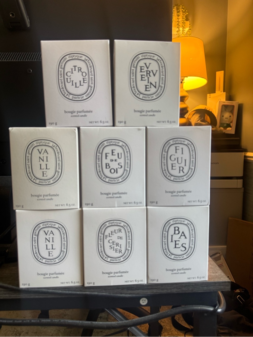Empty Diptyque candle boxes and candle jars.